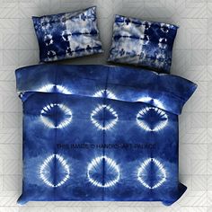 this is an image of a bed with blue and white tie dye designs on it