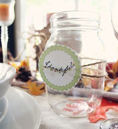 a glass jar filled with liquid sitting on top of a table next to a plate