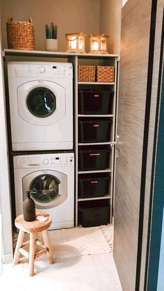 a washer and dryer sitting in a room next to each other with baskets on the shelves