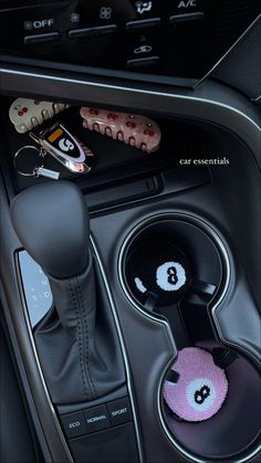 the interior of a car with buttons and steering wheel knobs on it's center console