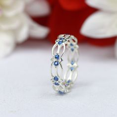 a white gold ring with blue sapphire stones