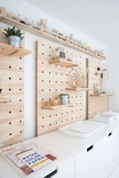 a white table topped with lots of wooden shelves