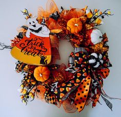 a halloween wreath decorated with pumpkins and decorations