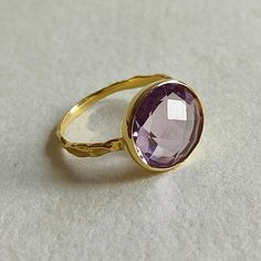 ITEM DESCRIPTION: >> The Ring is made from Solid 14K Yellow Gold. Gemstone used is absolutely natural and ethically sourced.  >> Natural Pink Amethyst in round shape briollette cut and bezel setting is studded on it with utmost precision.  Gem: Pink Amethyst  Gem size: 12 mm & Round   Gem weight: 4.90 carats Gold purity: 14K (58.33% approx.) Gold weight: 1.50 grams  Gross weight : 2.48 grams The Gold purity is guaranteed and it comes with authentic 14K gold hallmark. Since these Rings are handma Gold Faceted Amethyst Ring, Elegant Faceted Amethyst Ring In Yellow Gold, Faceted Amethyst Ring In Yellow Gold Fine Jewelry, Elegant Gold Faceted Amethyst Ring, Elegant Gold Amethyst Ring With Faceted Detail, Luxury Purple Ring With Bezel Setting, Elegant Gold Amethyst Ring With Faceted Cut, Purple Sapphire Ring In 14k Gold For Wedding, Faceted Yellow Gold Amethyst Ring