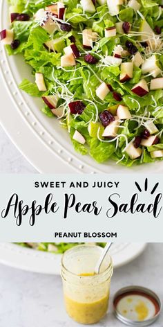 a salad with apples and cranberries in it on a white plate next to a jar of dressing