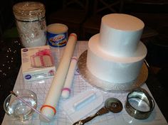 a table topped with lots of different types of cake decorating tools and decorations on top of it