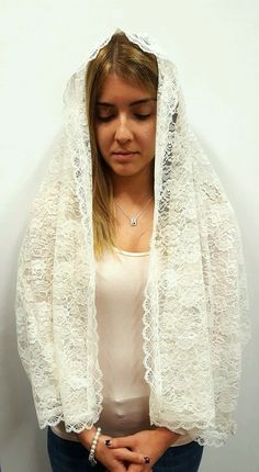 Wearing chapel veils during Mass and when praying had always been a traditional practice for centuries. Even though it is not mandatory, many women still choose to wear veils or other headcoverings as a sign of reverence , humility and modesty before God. This beautiful rectangular chapel veil is made entirely of italian lace and presents a rose embroidery pattern and scalloped edges. It is available in three different colors: white, ivory and black. Perfect for women of all ages, it is long eno White Shawl For Traditional Ceremonies, Traditional Lace Shawl With Lace Trim, Traditional Lace Dupatta Shawl, Traditional White Veil, Chapel Veils, Chapel Veil Catholic, Rose Embroidery Pattern, Real Rose Petals, Chapel Veil