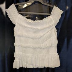 Beautiful White Ruffled Off-Shoulder Blouse New Without Tags 80% Nylon 20% Spandex. Stretch Top With Ruffled Straps And Details, Casual White Tiered Top, White Tiered Casual Tops, Ruched Ruffle Sleeve Top For Summer, Summer Ruched Top With Ruffle Sleeves, White Fitted Blouse With Smocked Back, Fitted White Blouse With Smocked Back, White Stretch Blouse With Ruched Detail, White Ruched Stretch Blouse