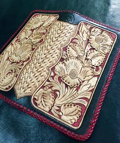 two leather coasters with intricate designs on them