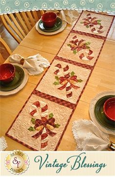 the table runner is decorated with red bows and green leaves, along with other placemats