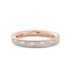 a rose gold wedding band with baguettes and diamonds on the side, set in 18k white gold