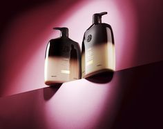 two bottles of body lotion on a purple and pink background with shadows from the left