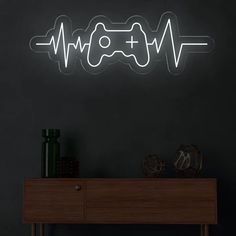 a neon sign that is on the side of a wall next to a wooden table