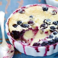 two pictures of blueberry cheesecake in a bowl with spoons next to it