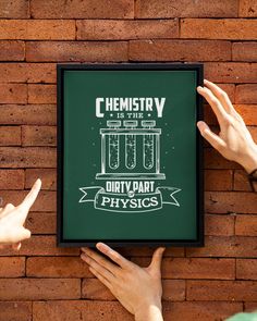 two hands pointing at a poster on a brick wall that says chemstry is the only dirty dart physics