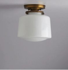 a white light hanging from a ceiling fixture