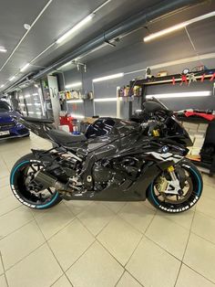 a black motorcycle parked inside of a garage