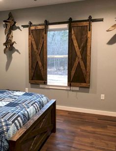 a bedroom with a bed and two wooden barn doors on the wall above it's headboard