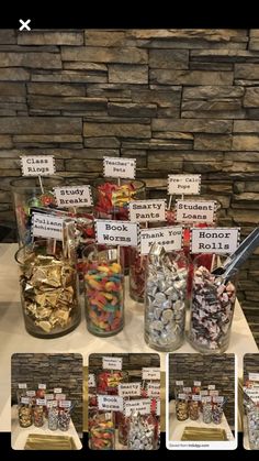 there are many different types of candies in jars on the table with signs above them