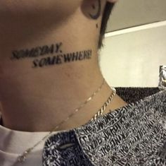 a man with a tattoo on his neck saying someone is somewhere where he wants to be