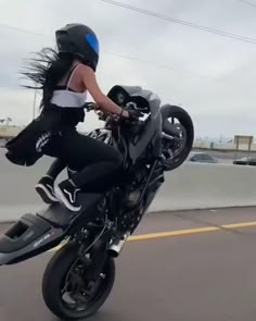 a woman riding on the back of a motorcycle