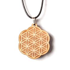 a wooden flower of life pendant on a black cord