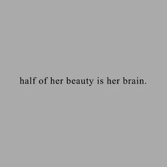 an image of the words half of her beauty is her brain on a gray background