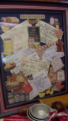 a collage of letters and other items is displayed in a frame on a table