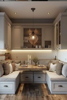 a kitchen with lots of white cabinets and wooden flooring, along with two couches that are facing each other