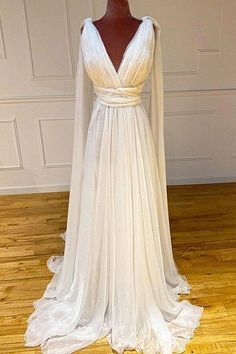 a white wedding dress with long sleeves on a mannequin