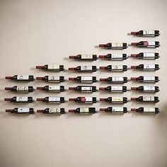 a bunch of wine bottles are arranged on the wall next to a computer monitor and keyboard