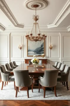 a dining room table with chairs and a chandelier hanging from the ceiling above it