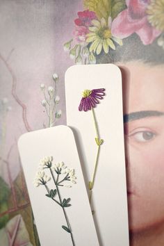 two bookmarks with flowers on them next to each other