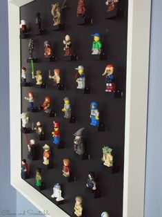 legos are arranged on a black board in front of a blue wall