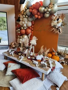 a table topped with lots of different types of balloons and other decorations on top of it