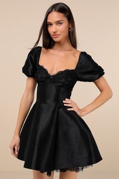 Charming and effortlessly captivating, the Lulus Enchanting Presence Black Taffeta Lace Puff Sleeve Mini Dress will have everyone entranced by the end of the night! Structured woven taffeta shapes a flirty sweetheart neckline and a lace-trimmed bodice with an under-bust seam, ruched detailing, and a cute bow at the center, all framed by short puff sleeves (with elastic at the shoulders and cuffs). The fit-and-flare silhouette continues down to a skater-style skirt that finishes at a mini hem wit Short Prom Dresses For Teens Black, Short Black Wedding Dress, Black Dress For Graduation, Black Dress Graduation, Black Dresses Short, Black A Line Dress, Banquet Outfit, Senior Banquet, Black Puff Sleeve Dress