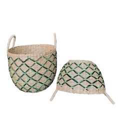 two baskets sitting next to each other on top of a white surface with green trim