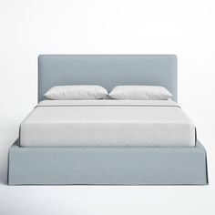 a bed with white pillows and blue headboard