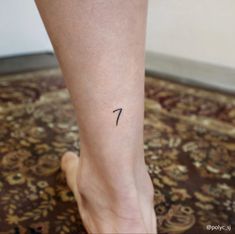 a woman's foot with the number seven tattoo on her left leg and right ankle