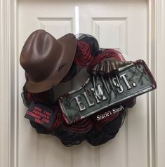 a door hanger with a cowboy hat and sign on it that says elm street