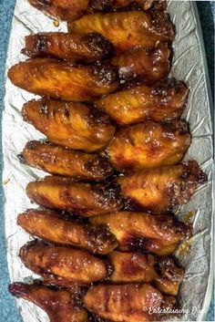 chicken wings on tin foil lined up in a row, ready to be cooked for the oven