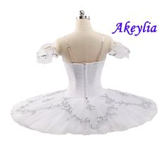 a white ballerina dress on display with the name akeyja written above it