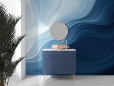 a bathroom with blue and white waves painted on the wall next to a vanity sink