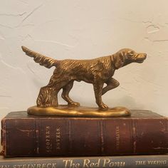 a golden dog figurine on top of two books