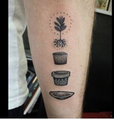 a person with a tattoo on their arm has a plant growing out of the pot