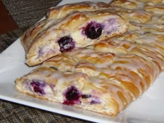 blueberry scones on a white plate with icing