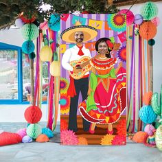 an image of a mexican couple on the dance floor with paper decorations around him and her