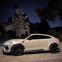 a white car parked on the street at night