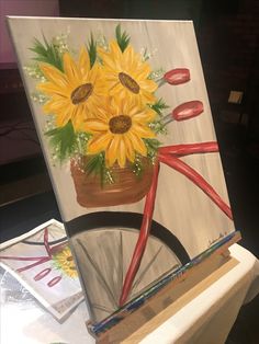 a painting of sunflowers in a pot on a bicycle painted with acrylic paint