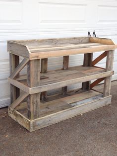 a wooden shelf sitting in front of a garage door